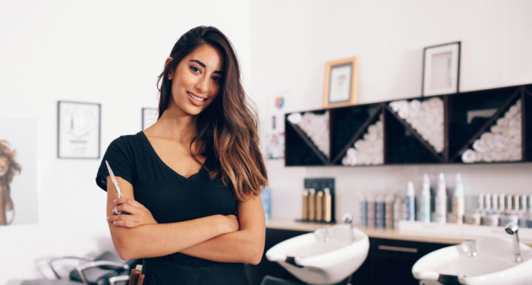 Female hairdresser standing in salon
